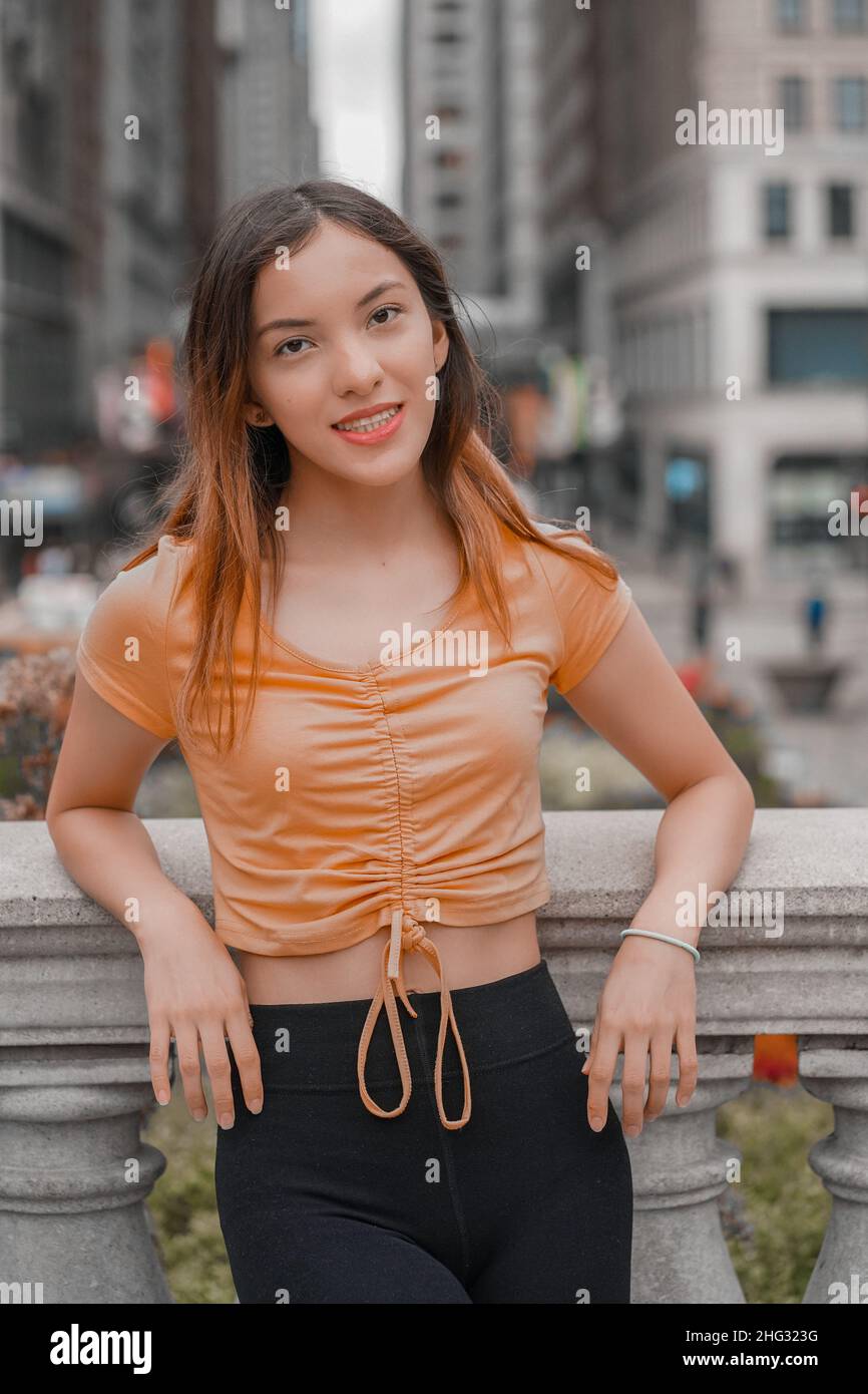 Vertical shot of a Caucasian (white) girl posing for the camera outside
