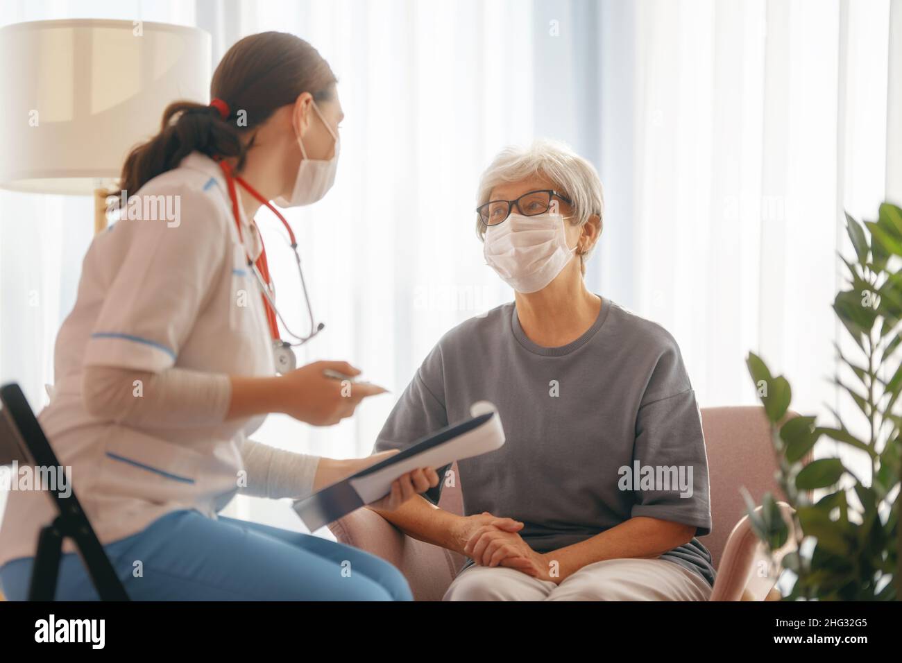 Senior woman taking off medical hi res stock photography and images Alamy
