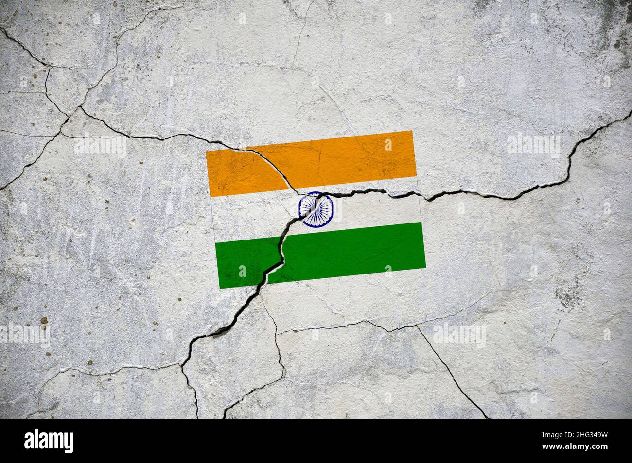 An old image of the flag of India on a wall with a crack. A crisis. Stock Photo