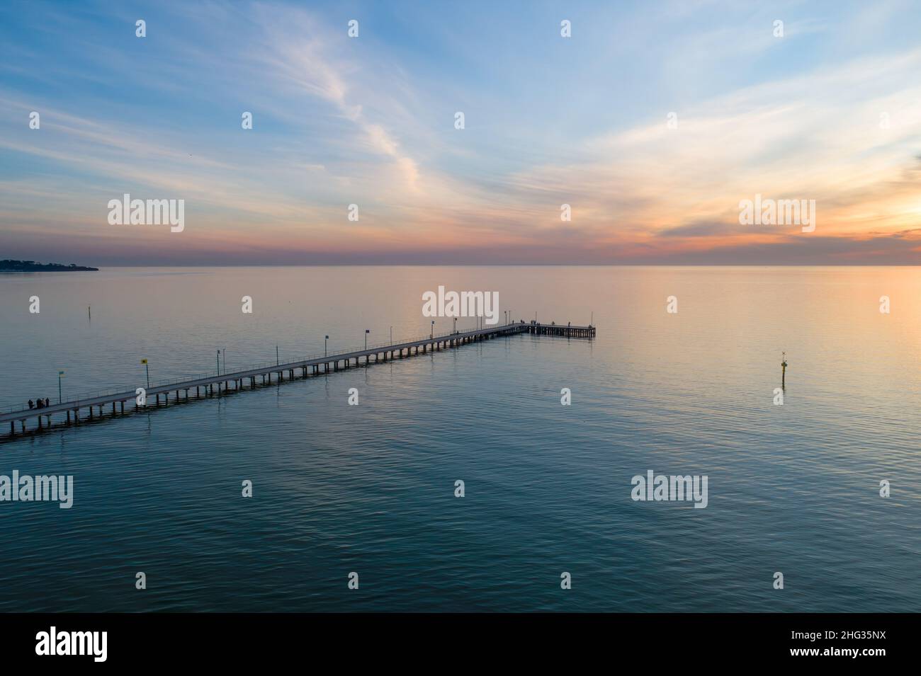 Long wooden pier at sunset - aerial view Stock Photo