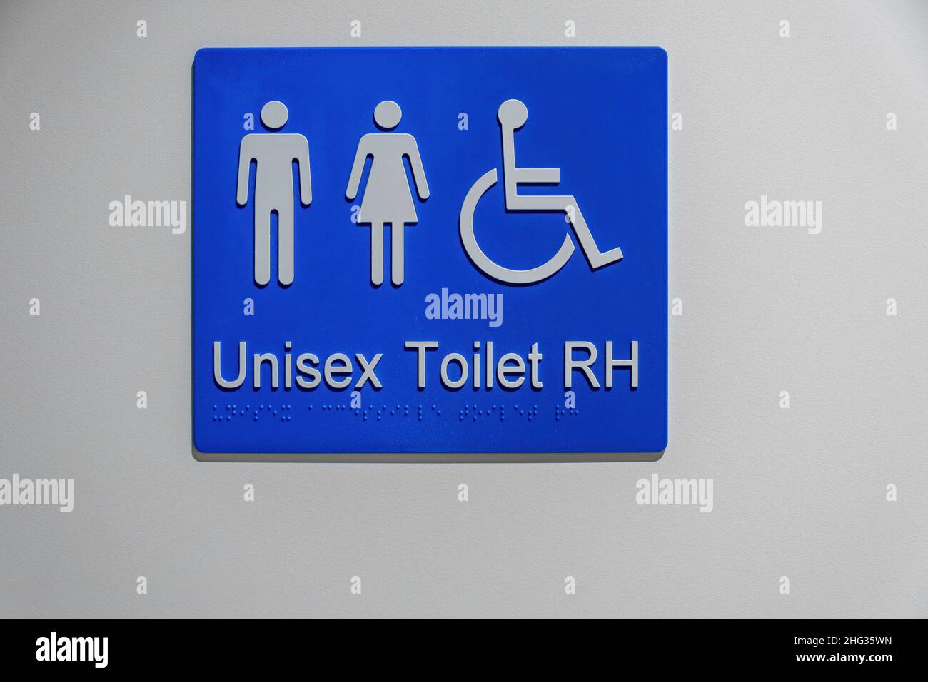 Unisex and Disabled toilet sign on white wall with Braille writing
