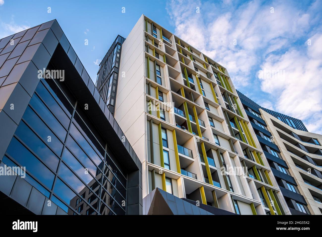 Looking up at modern residential buildings and blue sky Stock Photo