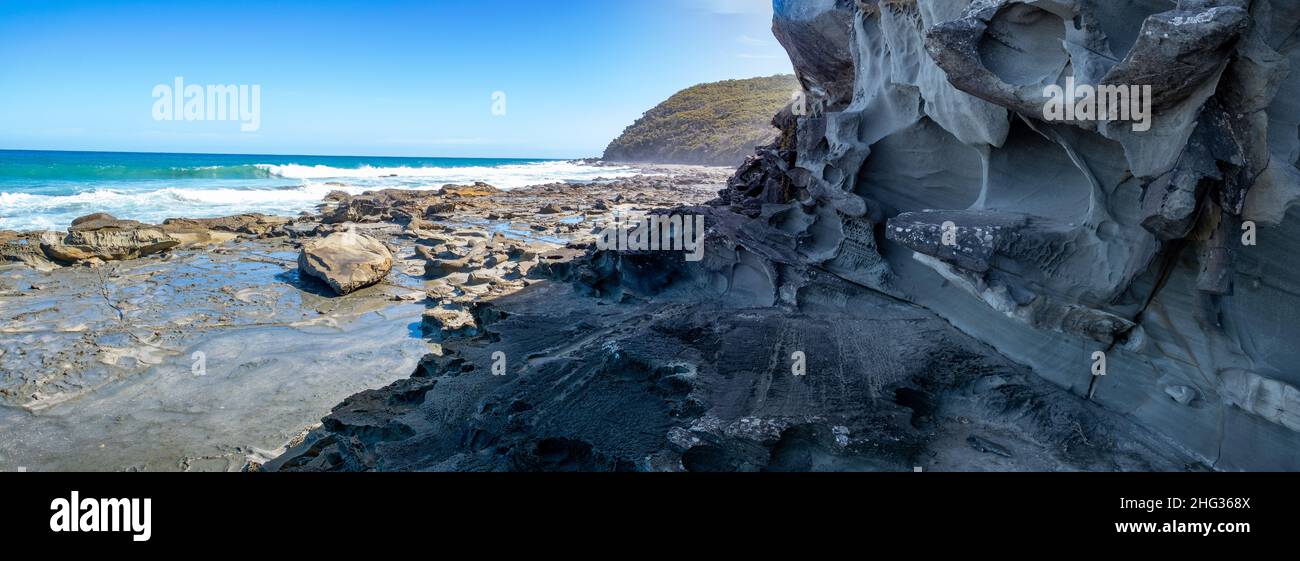 Eroded rock formations on ocean shore in the summer Stock Photo
