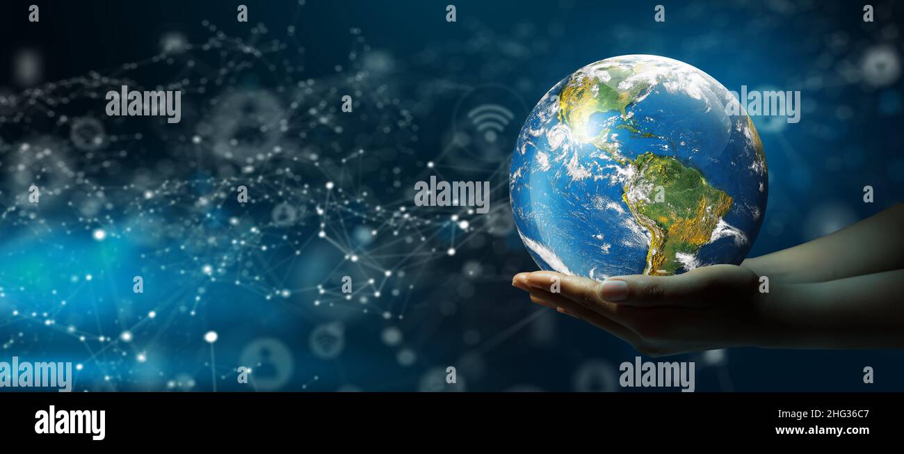 Businessman hand holding World Technology Connection with Abstract Background. Global Connected Concept. Elements furnished by NASA. Stock Photo