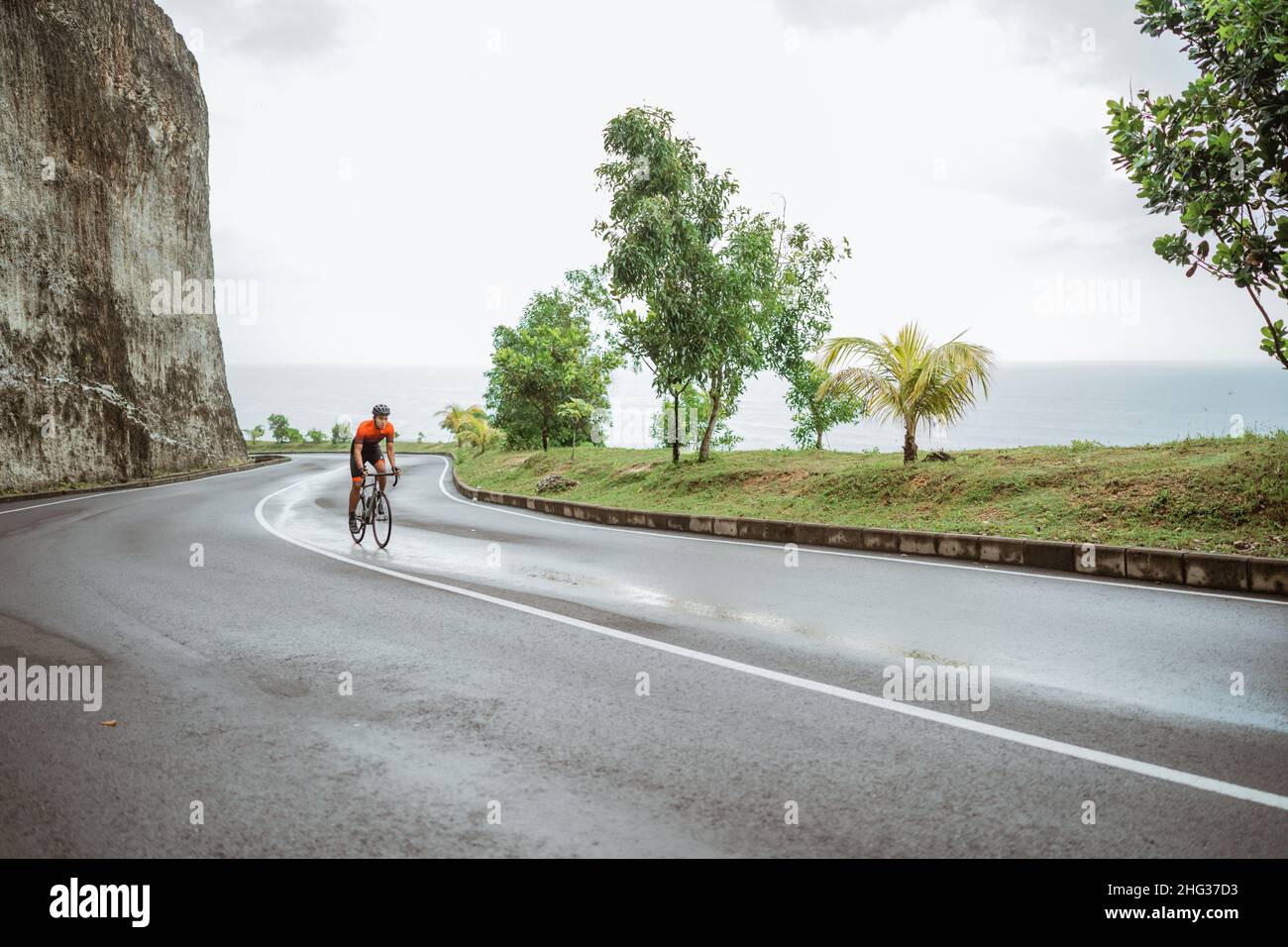 asian male cyclist riding in beautiful road Stock Photo - Alamy