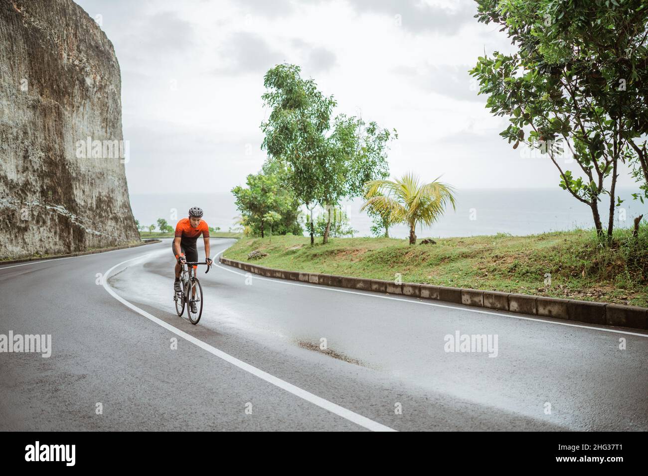 asian male cyclist riding in beautiful road Stock Photo - Alamy