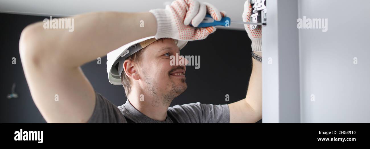 Man installing wooden door hinges Stock Photo