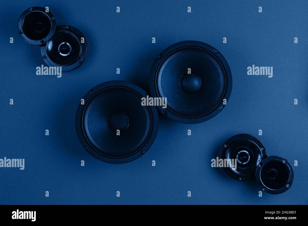 Car audio system. A set of speakers on a blue background.  Stock Photo