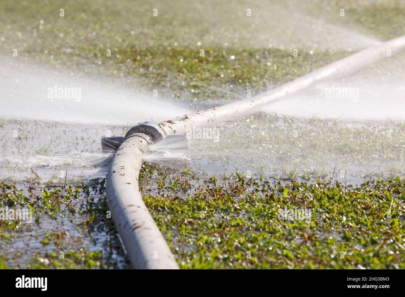 wasting water water leaking from hole in a hose Stock Photo Alamy