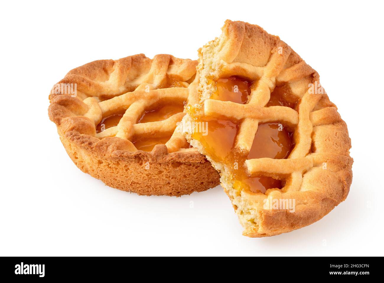 One whole and one half eaten apricot tartlet with lattice isolated on white. Stock Photo