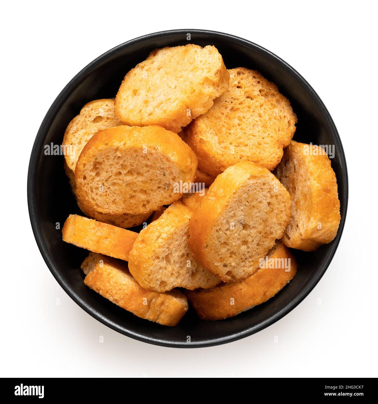 Olive and tomato bruschetta chips in a black ceramic bowl isolated on white. Top view. Stock Photo