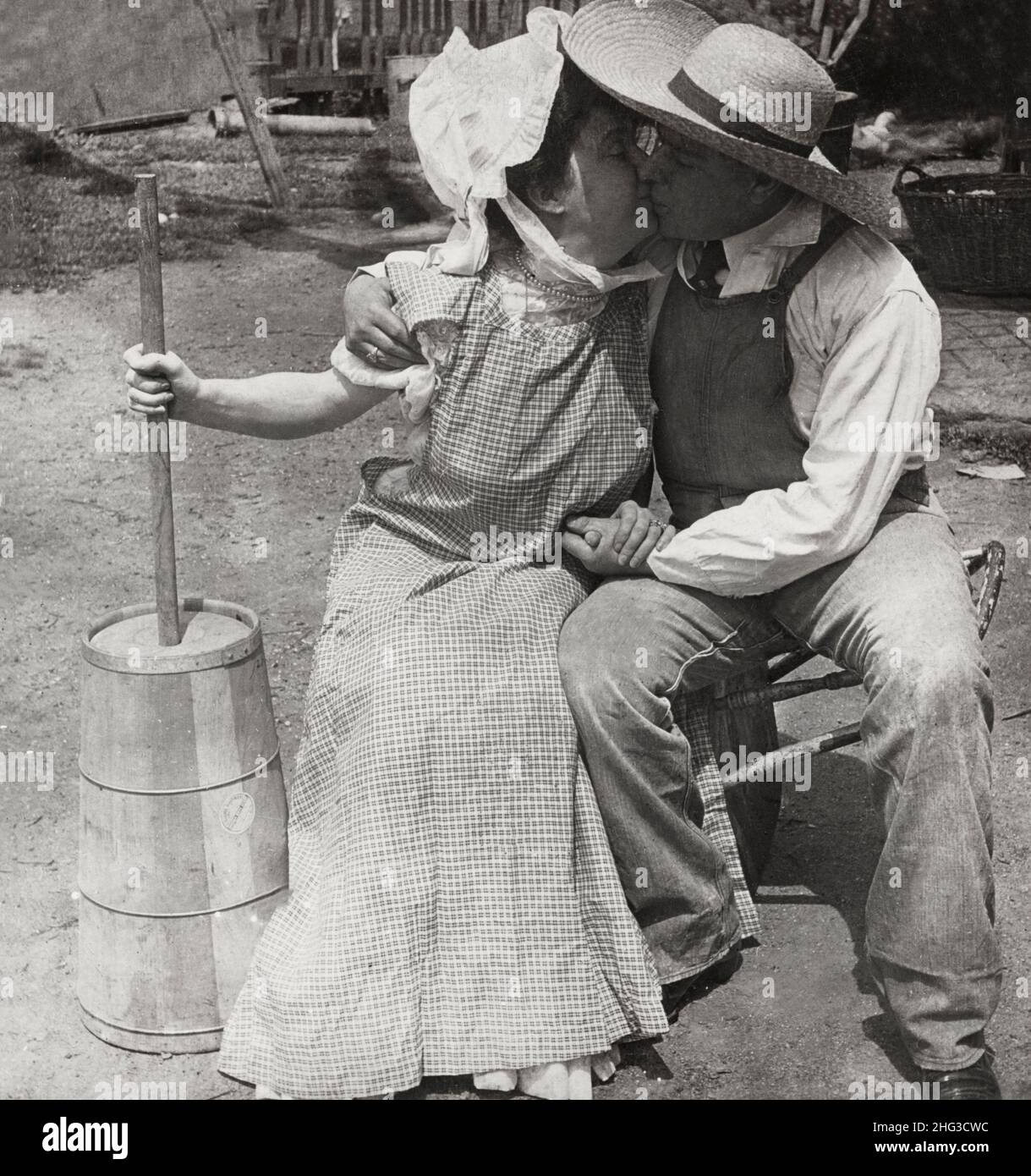 Vintage photo of love. Chinning, not churning. 1906 Farmer and milkmaid
