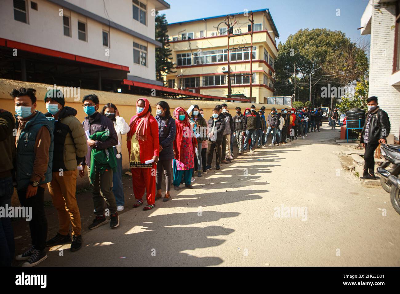 Kathmandu, Bagmati, Nepal. 18th Jan, 2022. People stand in line waiting for their turn to get inoculated with anti-COVID vaccines at Teku Hospital in Nepali capital Kathmandu. Serpetine lines stretching far and wide as government makes vaccination card mandatory to take public services or to be at public areas starting from 21 January, 2022. (Credit Image: © Amit Machamasi/ZUMA Press Wire) Stock Photo