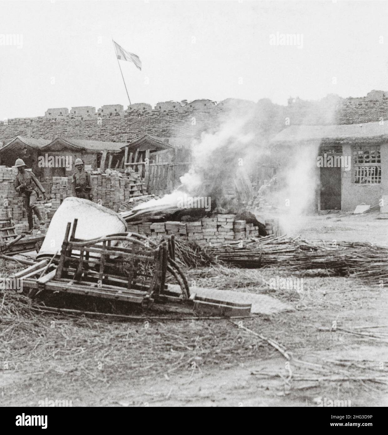 Vintage photo of the 19th century China. After the city's capture, burning bodies of Chinese outside the wall at South Gate, Tientsin, China. 1901 Stock Photo