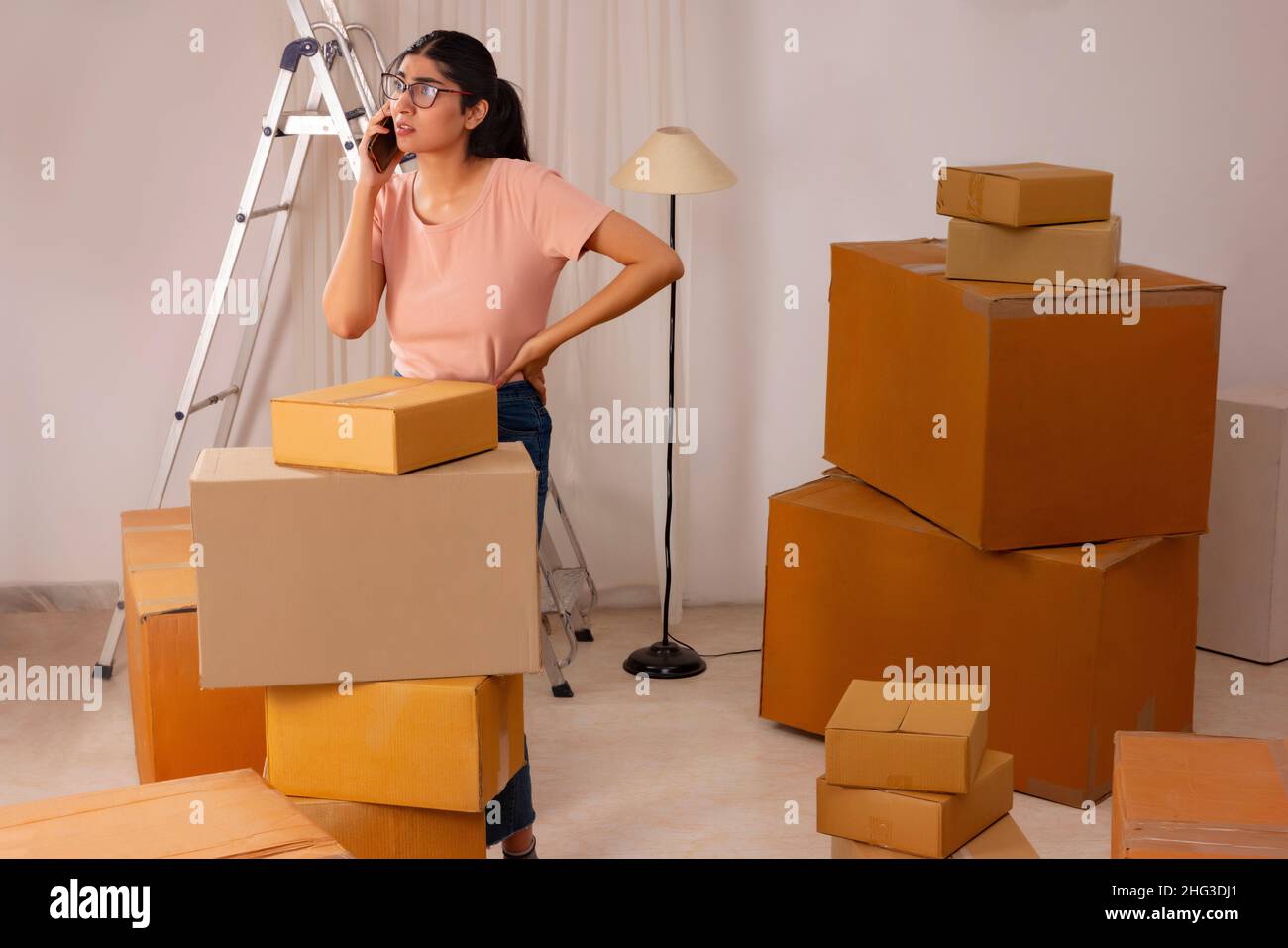 Adult girl talking on Smartphone during packing Stock Photo - Alamy