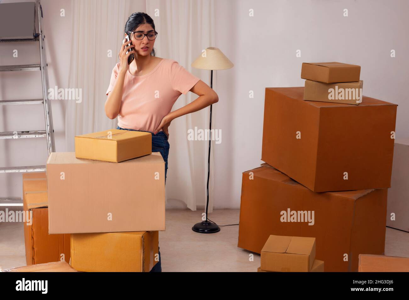 Adult girl talking on Smartphone during packing Stock Photo - Alamy