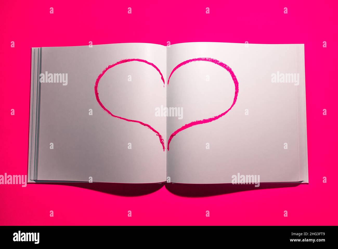Notebook with white blank pages for notes on pink background. Stock Photo