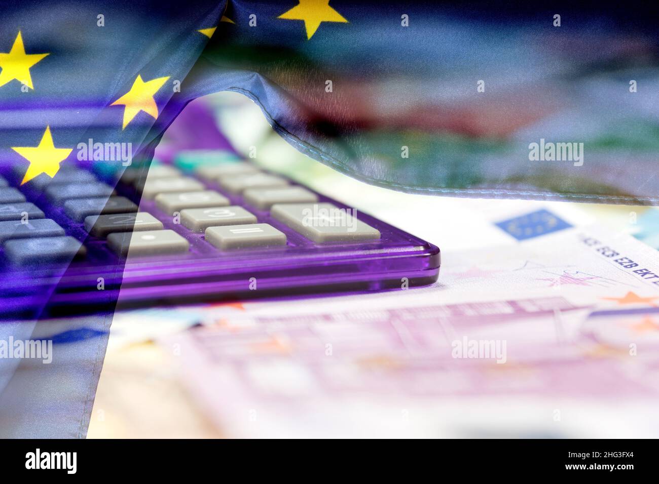 European Union flag, euro banknotes and a calculator Stock Photo