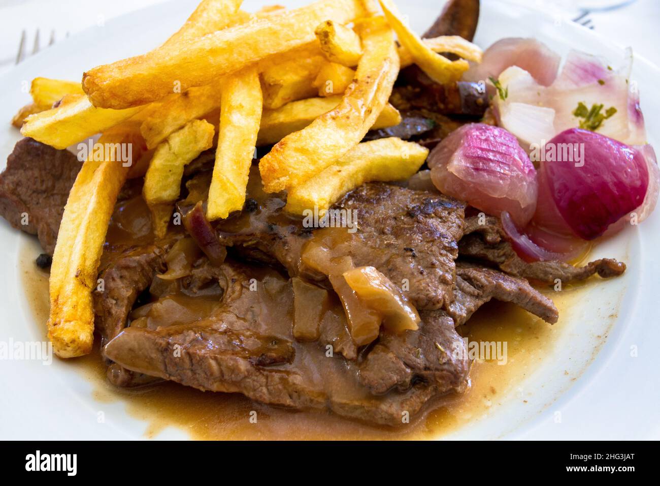 veal liver on a plate with fries and onions Stock Photo Alamy