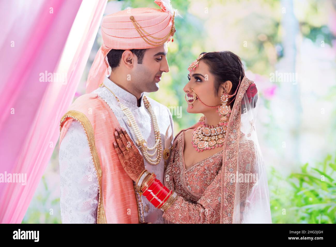 Indian wedding couple posing in front of camera hi-res stock ...
