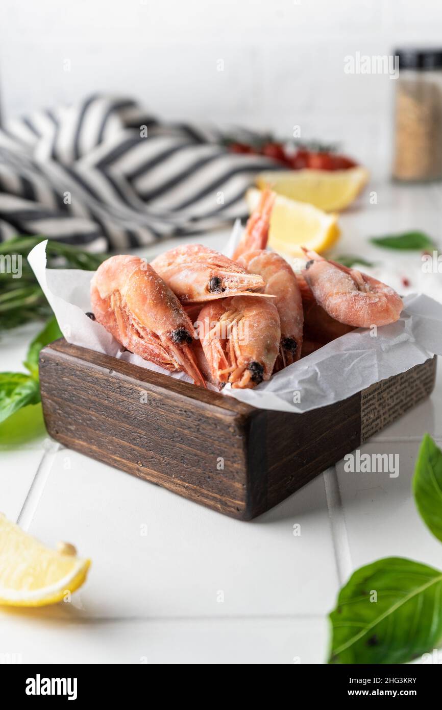 Thawed peeled shrimp, seafood, delicacy. on a white background, in a ...