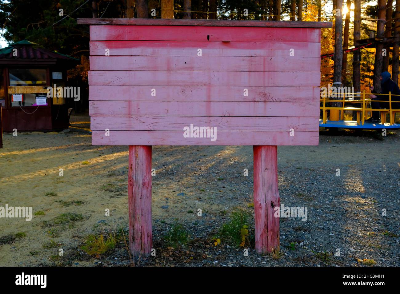 Russia, Bashkiria-09.10.2021-Wooden billboard for announcements on the beach. Painted with pink paint, no inscriptions. Stock Photo