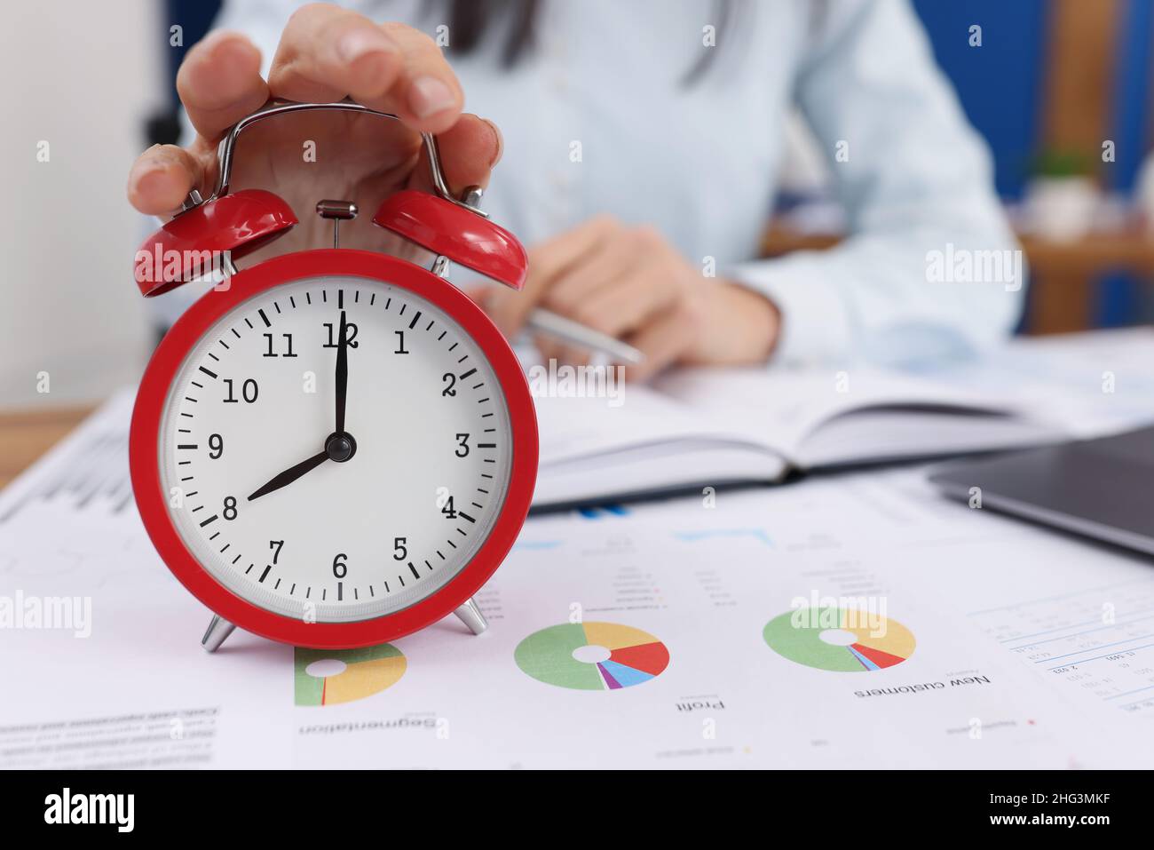 Woman turn off timer on clock at eight oclock in morning, time start