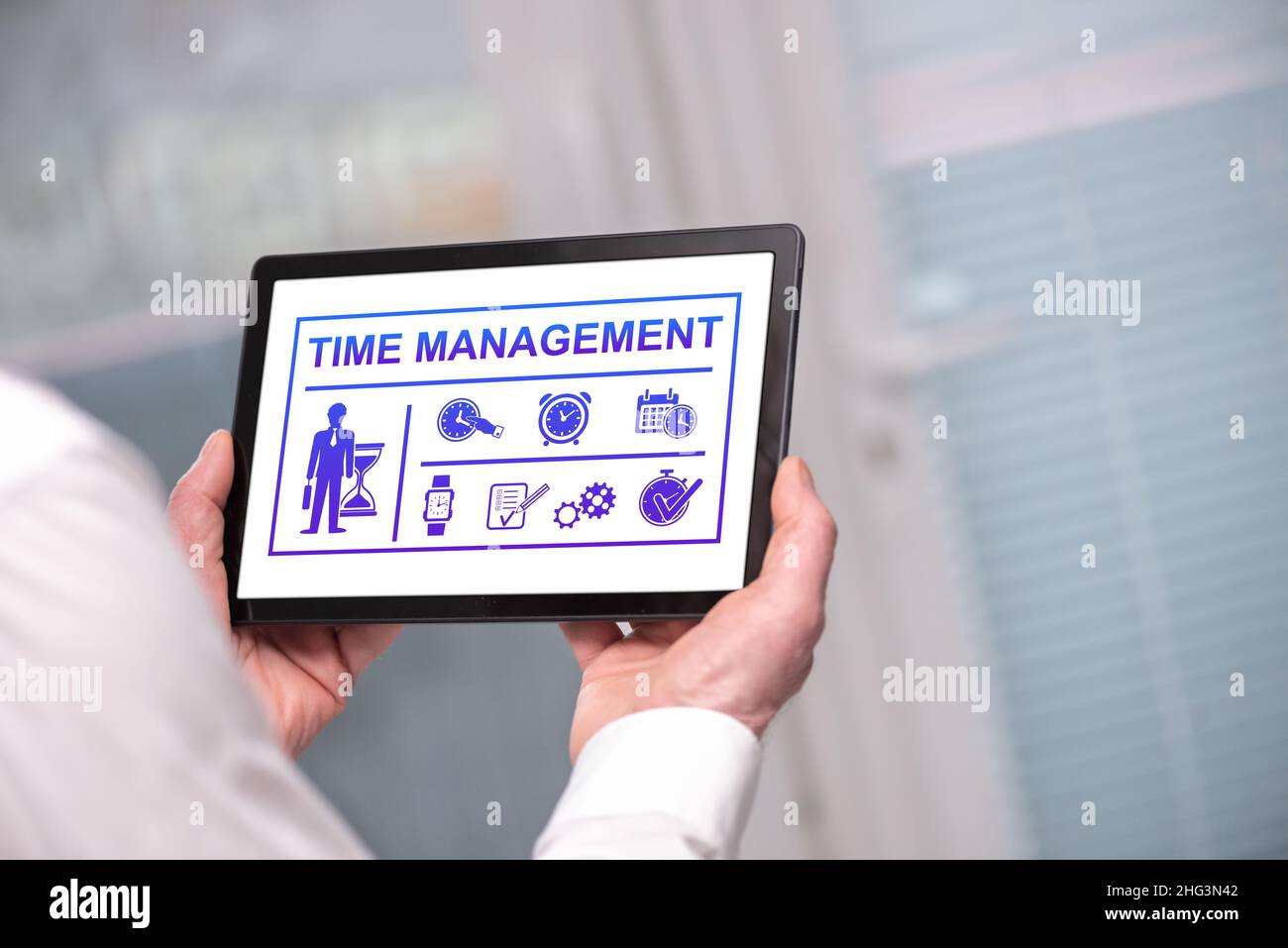 Time management concept shown on a tablet held by a man Stock Photo