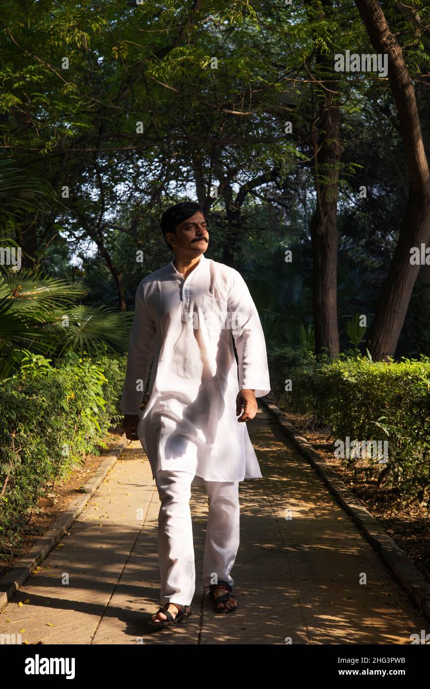 Indian man walking side view hi-res stock photography and images - Alamy