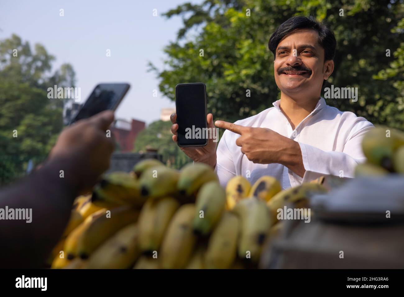 Man paying seller through online using Smartphone Stock Photo