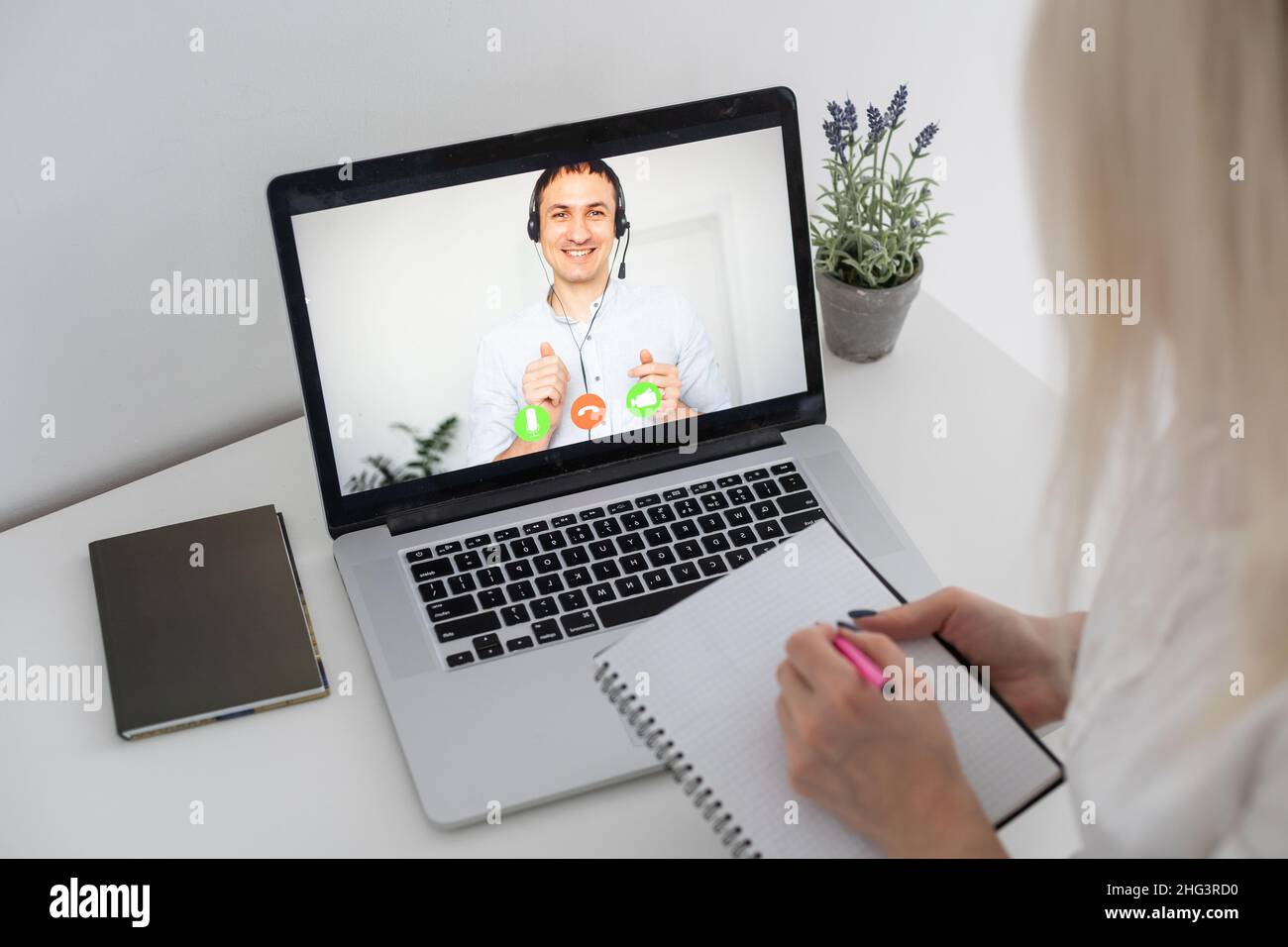 Caucasian female teacher using computer and laptop on video call with ...