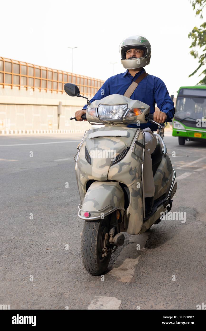 Premium Photo  A man with his new scooter and helmet giving thums up full  size image