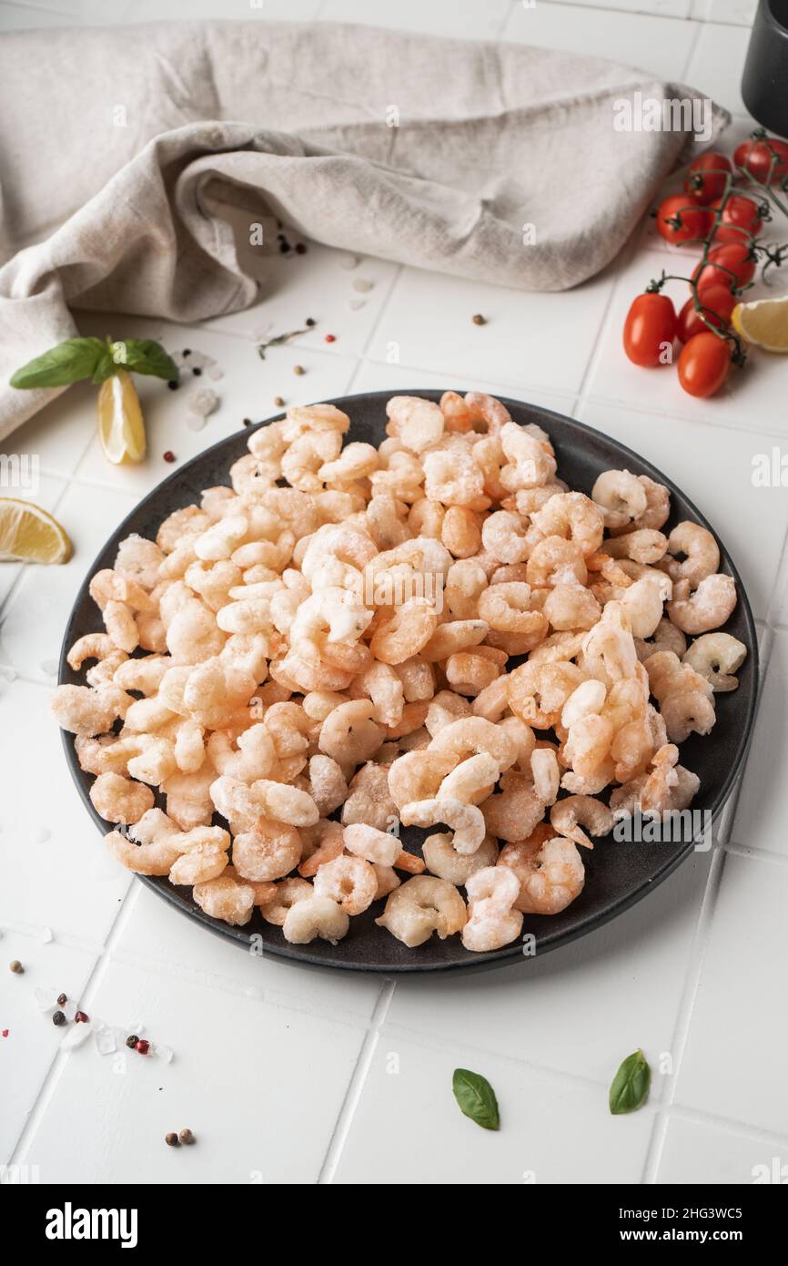 Thawed peeled shrimp, seafood, delicacy. on a white background, in a ...