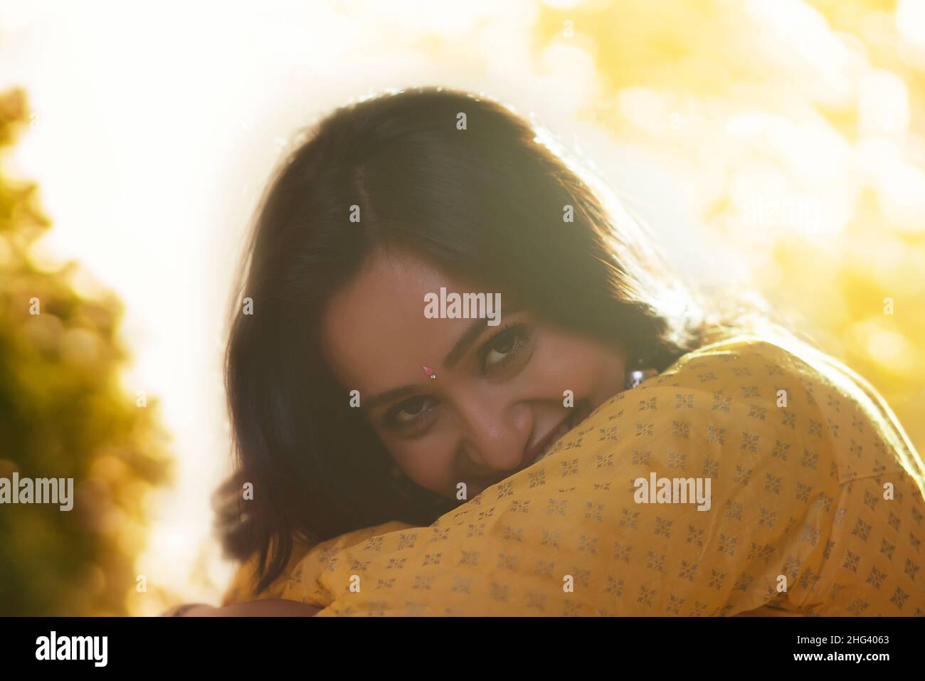 Close-up portrait of shy woman looking at camera Stock Photo