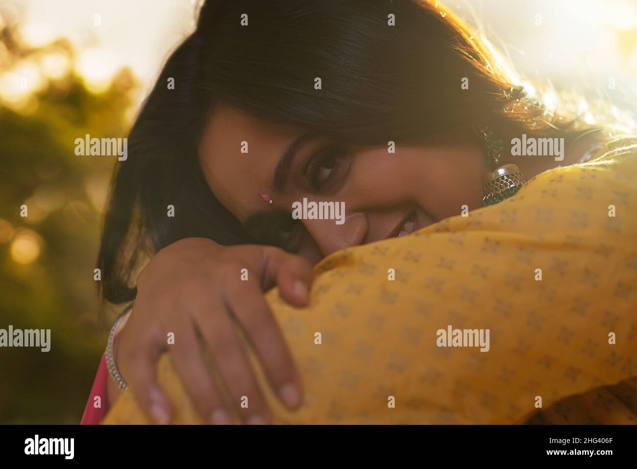 Close-up portrait of shy woman looking at camera with cross-eyed Stock Photo