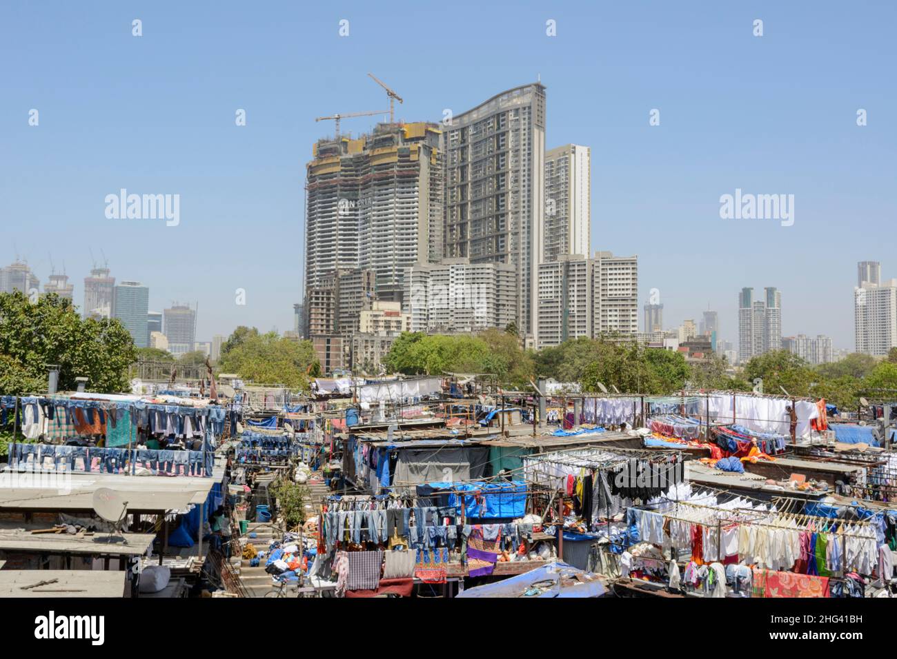 View of modern Mumbai City skyscrapers next to the traditional Mahalaxmi Dhobi Ghat, the largest outdoor laundry in Mumbai, Maharashtra, India Stock Photo