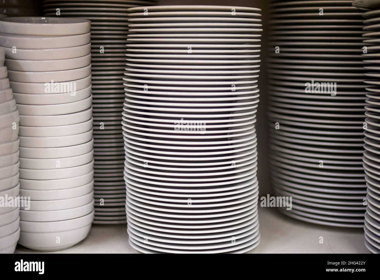 a stack of plates in a restaurant kitchen Stock Photo Alamy