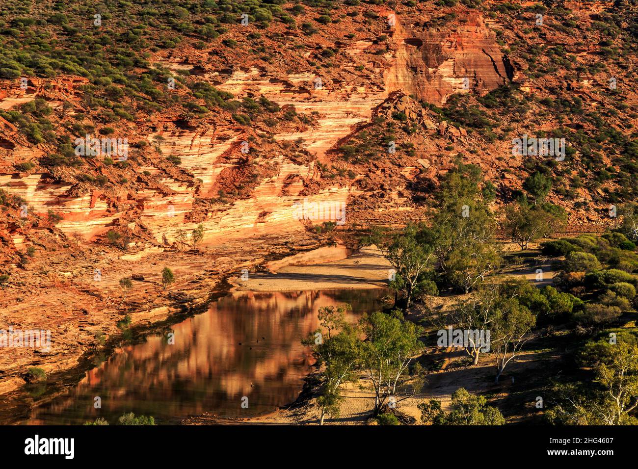 Red and white banded tumblagooda sandstone bluff in Murchison River Gorge at Kalbarri National Park Stock Photo