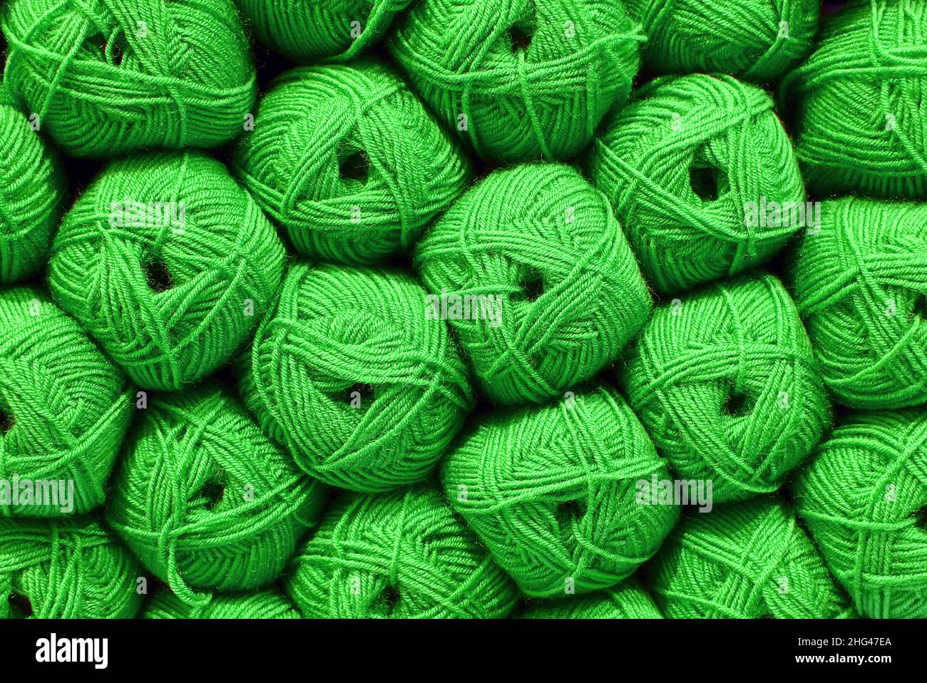 Green Ball of wool. Beautiful colored wools ball. Wool texture. Skeins of yarn. Natural material for knitting, creative idea. Abstract diy background. Stock Photo