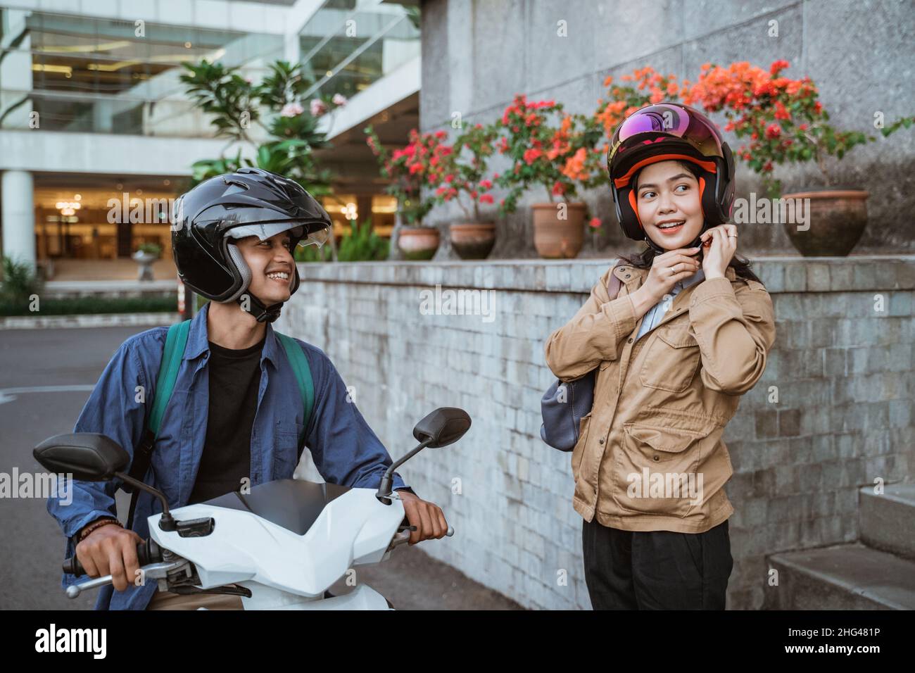 A man and woman wear helmets when they go Stock Photo - Alamy