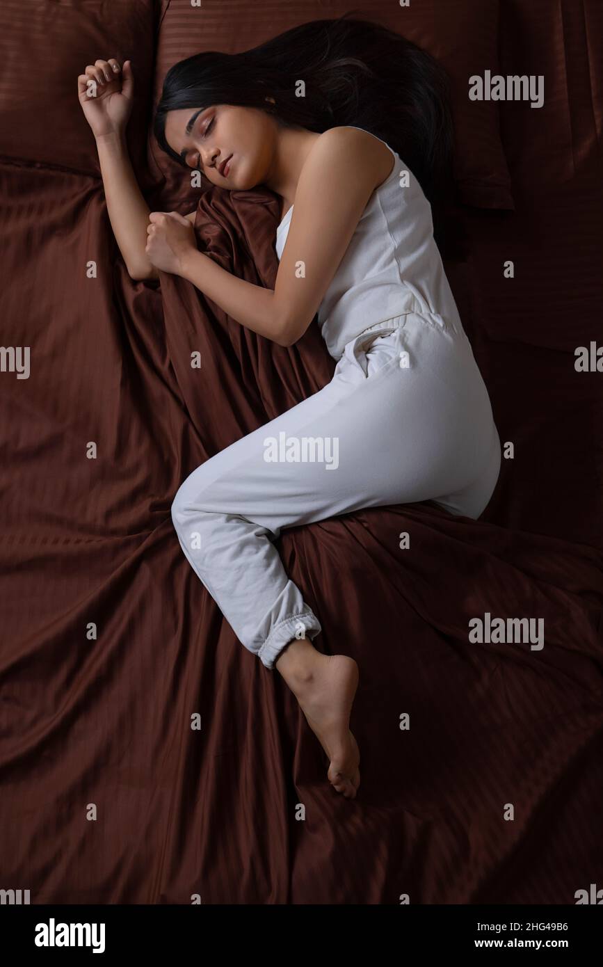 Young beautiful girl sleeping on bed Stock Photo