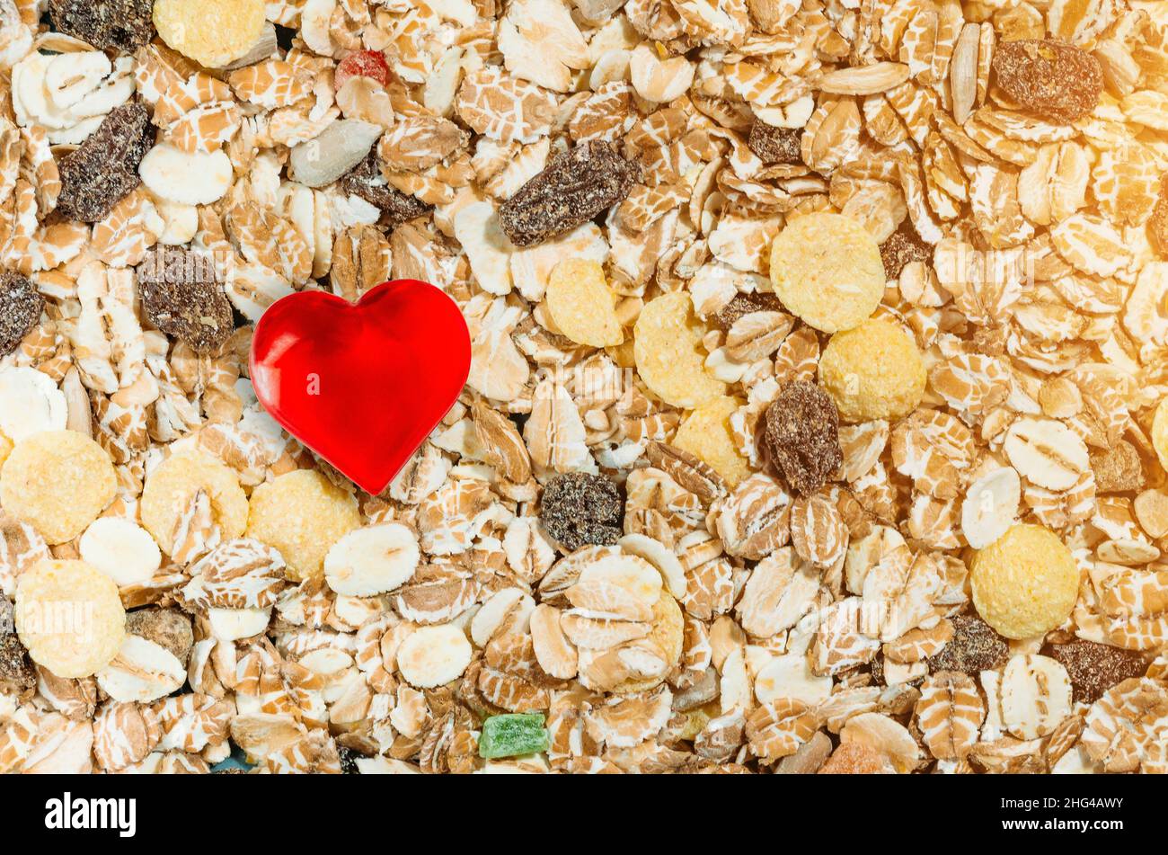 Healthy food, muesli raisins background and heart symbol Stock Photo