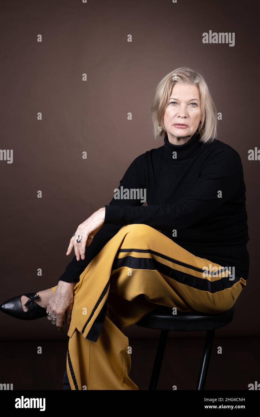 Portrait of elegant mature woman in fashion clothessitting on chair and ...