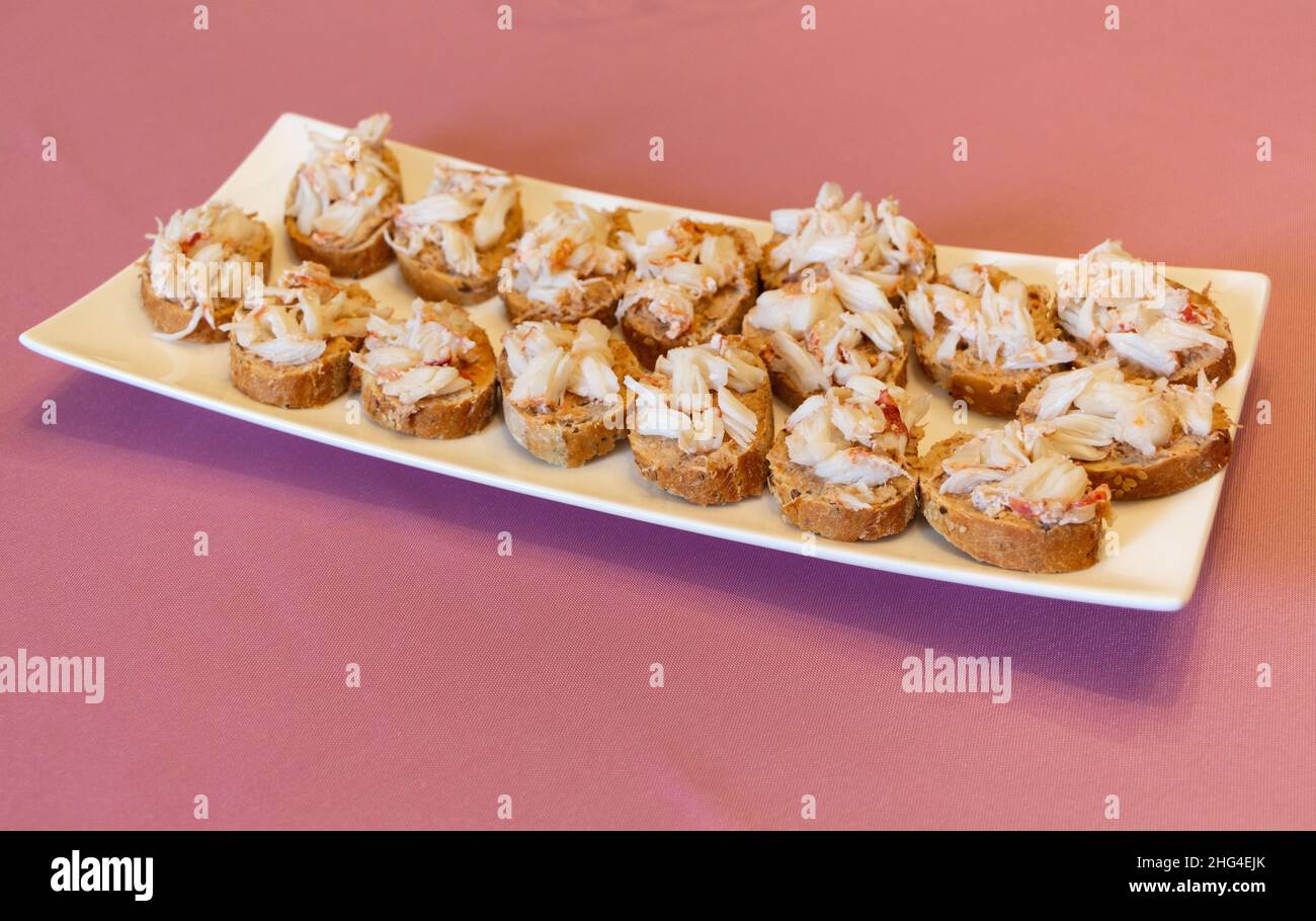 Baguette toast with lobster pieces as appetizer for luxury dinner Stock