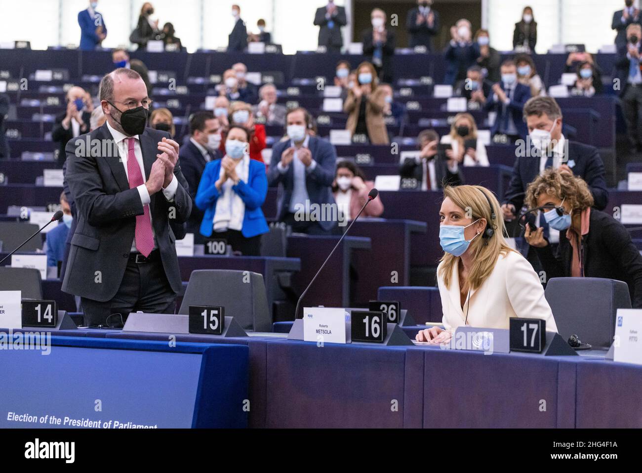 18 January 2022, France, Straßburg: Roberta Metsola (r, Partit Nazzjonalista), EPP Group, sits in the European Parliament building after her election as President of the European Parliament while Manfred Weber (l, CSU), EPP Group, applauds her election victory together with other MEPs. Metsola was considered the favorite for the office and was able to prevail in the first round of voting. Photo: Philipp von Ditfurth/dpa Stock Photo