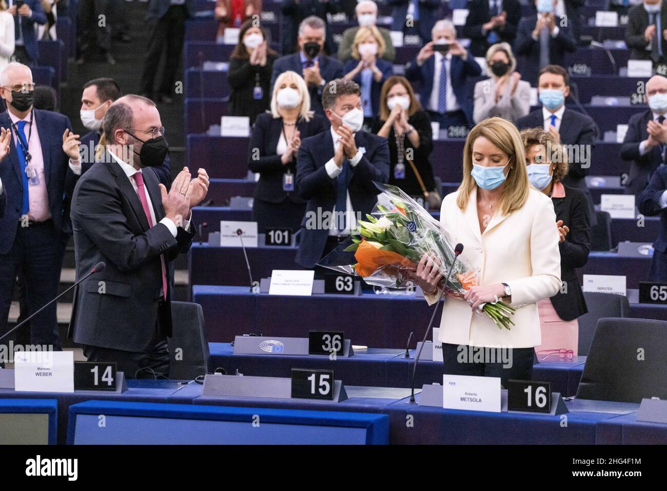 18 January 2022, France, Straßburg: Roberta Metsola (r, Partit Nazzjonalista), EPP Group, stands in the European Parliament building after her election as President of the European Parliament while Manfred Weber (l, CSU), EPP Group, applauds her election victory together with other MEPs. Metsola was considered the favorite for the office and was able to prevail in the first round of voting. Photo: Philipp von Ditfurth/dpa Stock Photo