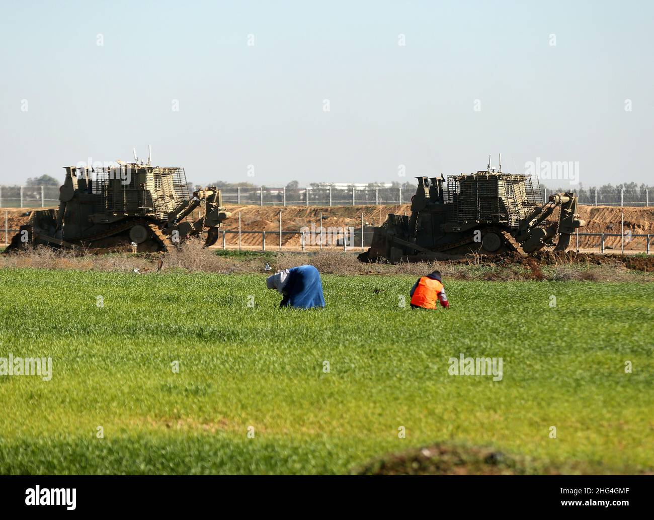 Gaza. 18th Jan, 2022. Israeli army bulldozers raze part of a farm in Khuza'a, east of southern Gaza Strip city of Khan Younis, Jan. 18, 2022. Credit: Yasser Qudih/Xinhua/Alamy Live News Stock Photo