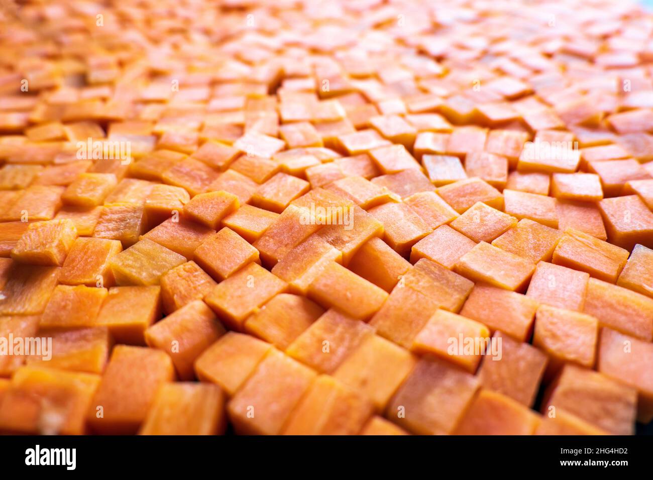 Fresh carrot cube pieces closeup background Stock Photo