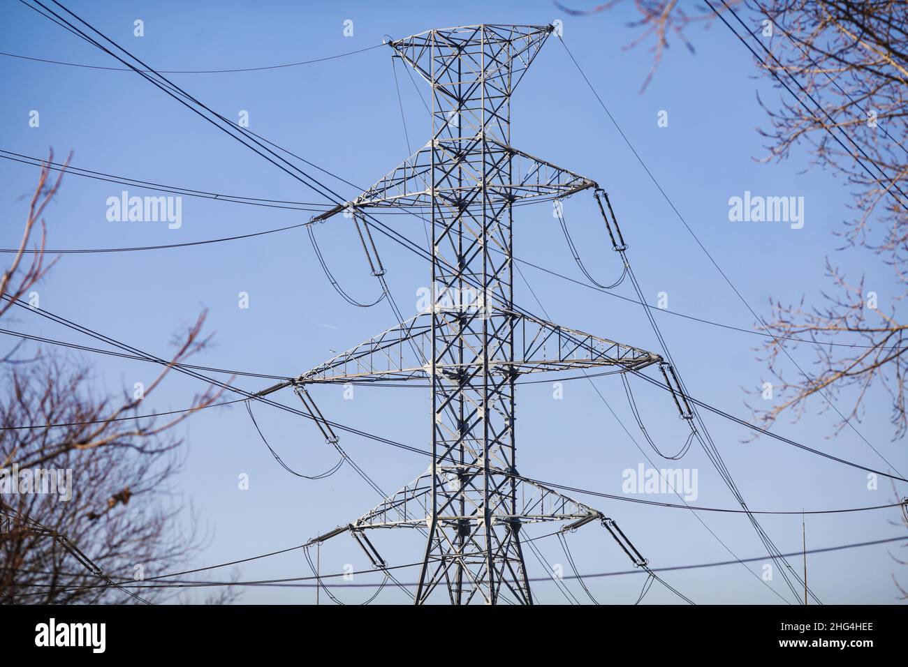 High voltage transmission lines on metallic poles in Bucharest, Romania. Stock Photo