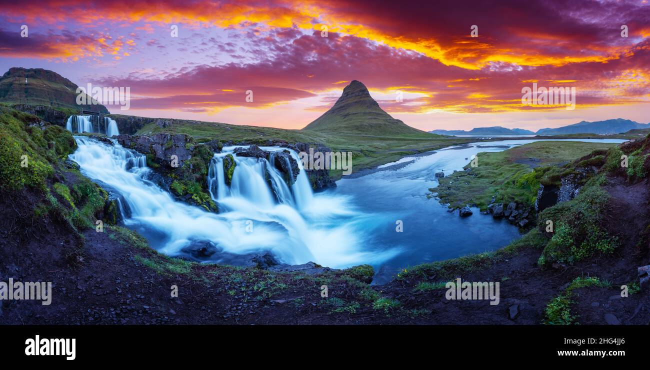 Gorgeous landscape with rising sun on Kirkjufellsfoss waterfall and Kirkjufell mountain, Iceland, Europe. Landscape photography Stock Photo